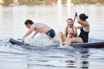 Family Enjoying Summer Fun on a Paddleboard on the Lake