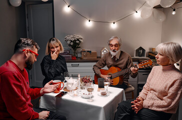 A group of family members enjoys quality time in a cozy home, featuring discussions, music...