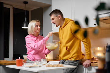 Couple Cooking Together in a Cozy Kitchen and Enjoying Baking Preparations
