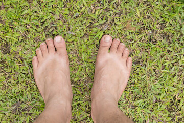 leg stand on the green grass yoga concept