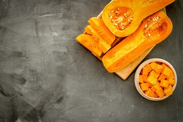 Pumpkin - slices on cutting board - on grey background top-down space for text