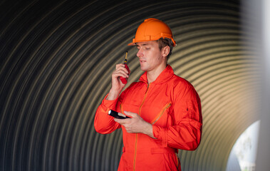 Mechanical engineer wearing safety uniform checking and inspection pipeline system.
