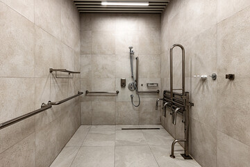 Accessible shower with safety grab bars and foldable seat in modern bathroom