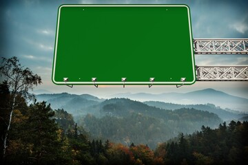 Green road sign by mountains