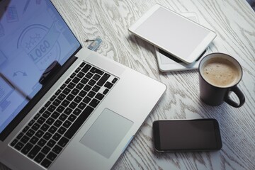 Various technologies with coffee cup on table in office © vectorfusionart