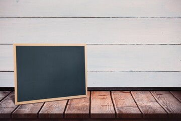 Obraz premium Black board on a wooden table
