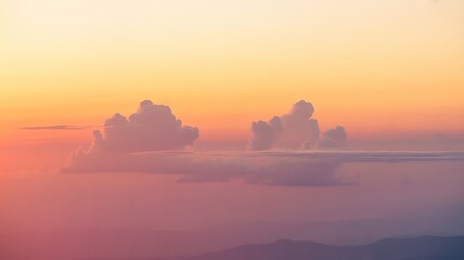 Beautiful sunset sky with fluffy clouds in shades of orange pink and yellow