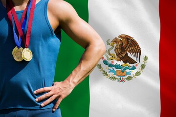 Midsection of medalist against Mexican flag