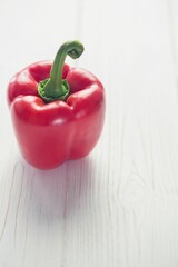Fresh red pepper on wooden table