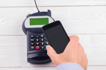 Man using smartphone to express pay