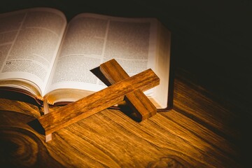 High angle view of wooden cross on bible