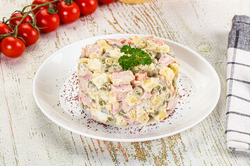 Russian traditional Olivier salad with sausages