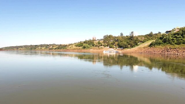 Aerial drone footage of the Friendship Bridge connecting Brazil and Paraguay over the Paran&aacute; River. The scene captures the international border near Foz do Igua&ccedil;u and Ciudad del Este, showing traffic 