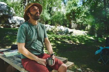 Relaxed Man Enjoying a Summer Day at a Mountain Campsite