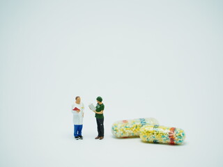 Mini toy of action figure at table with blurred. Miniature photography concept. Healthcare crew conceptual design with medicine.