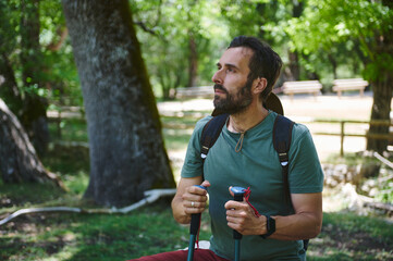 Male Adventurer Enjoying Scenic Hike in Lush Green Forest