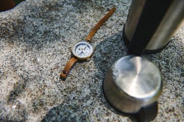 Explorer's Outdoor Camping Essentials on Stone Surface in Natural Lighting