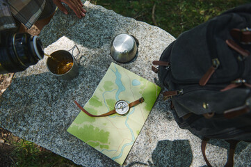 Exploration Essentials on Granite Surface Featuring Map, Compass, and Hiking Gear
