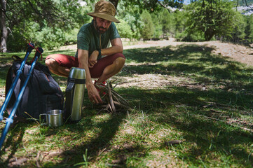 Man Setting Up Camp in a Forest During a Hiking Adventure