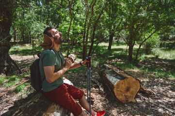 Man Enjoying a Peaceful Hiking Break in a Tranquil Forest Setting