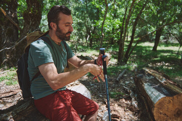 Man Hiking in Forest with Backpack and Trekking Pole in Summer