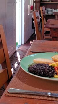 pan right arepas, perico, caraotas, cheese and shredded beef served in a rustic Venezuelan restaurant.
