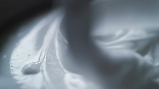 Closeup shots of a creamy texture being meticulously mixed with a spoon, perfect visuals for cooking demonstrations