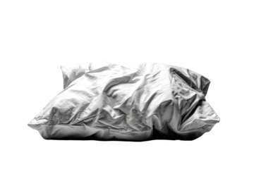 Crumpled white pillow against black