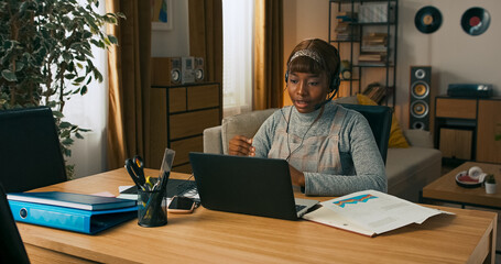 A girl prepares for an upcoming online meeting, typing quickly on her laptop to log important updates discussed with the previous client.