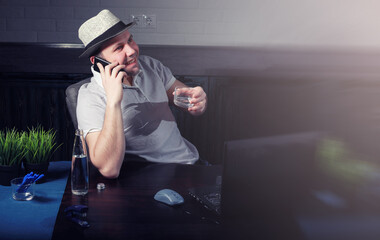 man at table and working on laptop