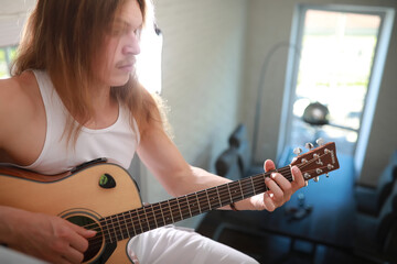 Young man with long hair with a guitar