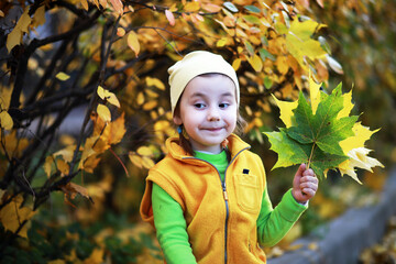 Children walk in the autumn park