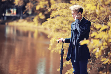Autumn rainy weather and a young man with an umbrella