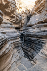 Unique volcanic rock formations at Las Grietas in Lanzarote. Deep cracks and fissures carved into...