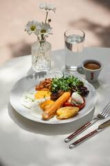 Portion of gourmet breakfast with sausage and fried eggs and coffee