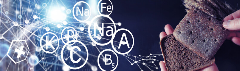 Fresh loaves of bread with wheat and gluten on a black table. Bakery and grocery concept. Fresh, healthy sorts of rye and white loaves food closeup. Fresh homemade bread with cereals.