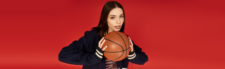 Stylish woman showcasing dynamic basketball skills in vibrant urban setting