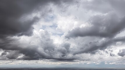 Obraz premium The Dramatic Sky Covered with Fluffy Gray Clouds Over the Horizon