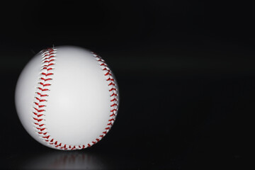American traditional sports game. Baseball. Concept. Baseball ball and bats on a black table.
