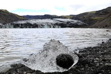 small piece of the Solheimajökull glacier that has broken off and melted into a clear ice diamond...