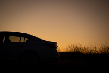Silhouette of a car on the twilight heath