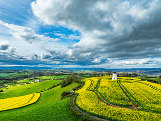 Rapeseed fields and Farms over Devon Windmill from a drone, Torquay, Devon, England