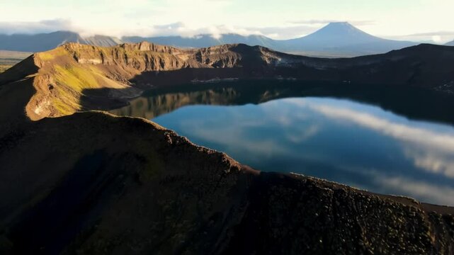 A serene crater lake reflects the sky in kamchatka, russia, a remote volcanic landscape and unesco world heritage site