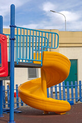 Yellow Plastic Spiral Slide Fun Activity for Children at Modern Playground