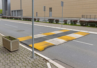 Yellow and White Speed Bump Made From Asphalt at Street in City