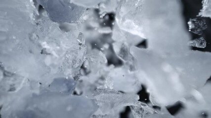 Super Slow Motion Shot of Ice Pieces Flying Towards Camera on Black Background at 1000fps. - Powered by Adobe