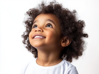 Portrait of a smiling African American kid looking up, happy little child isolated on white background, realistic photo.