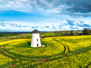 Rapeseed fields and Farms over Devon Windmill from a drone, Torquay, Devon, England