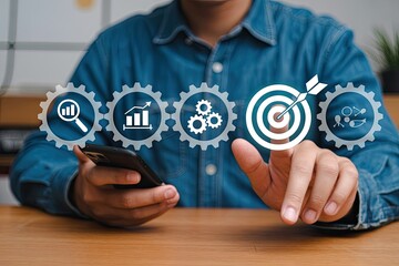 Man using smartphone to interact with digital interface displaying gears analytics growth chart target and team collaboration icons