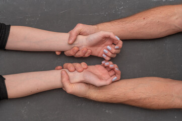 Man gripping woman wrist firmly, symbol of power, dominance and emotional tension, with physical grasp. Closeup of restrained female wrist by male and concept of relationship conflict and control